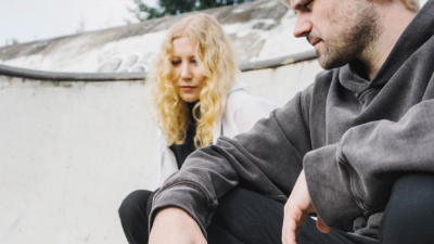 A woman and a man in a skateboard park